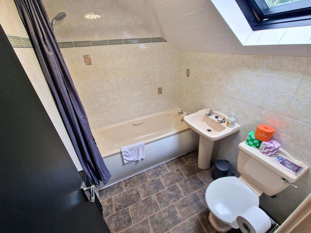 Bright, well-kept bathroom with a bathtub and o...