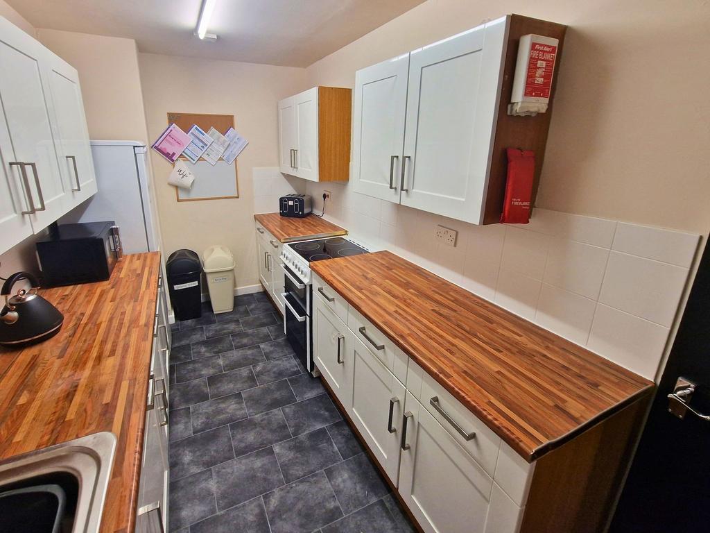 Bright, freshly fitted galley kitchen with long...