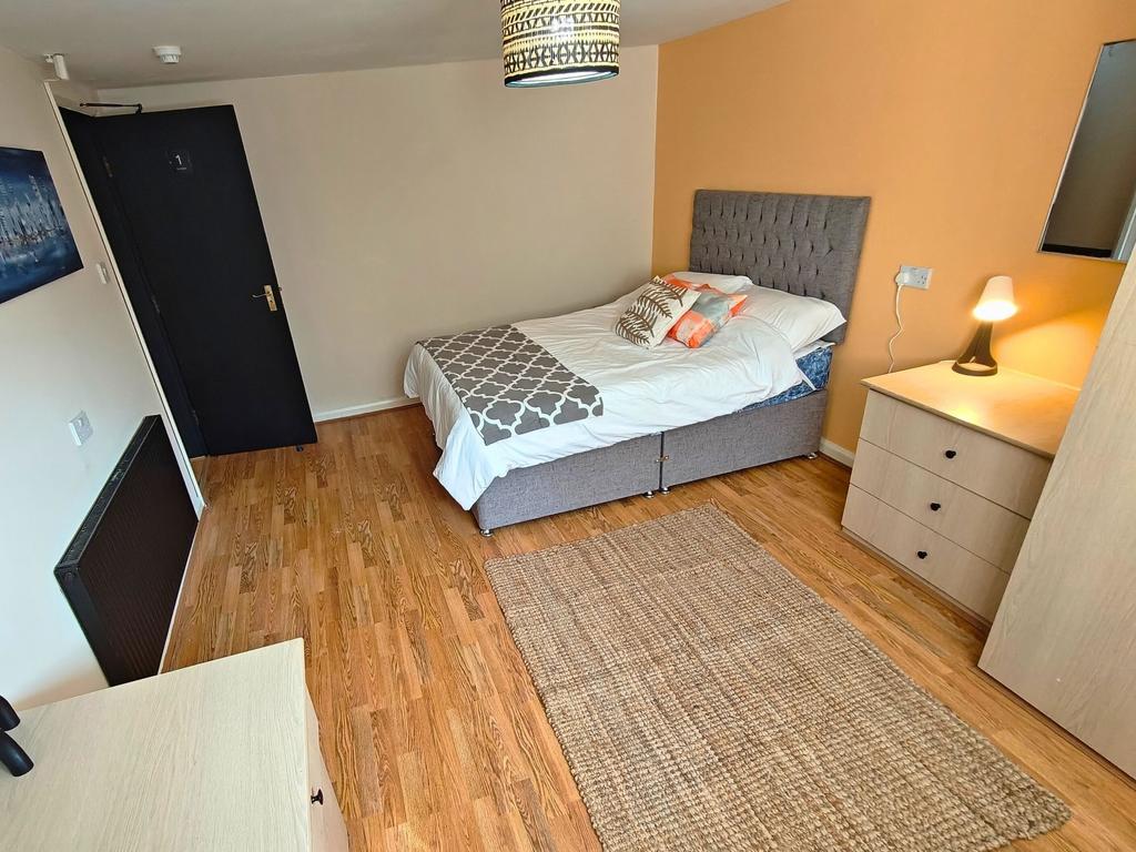 Bright, stylish bedroom with a comfortable doub...