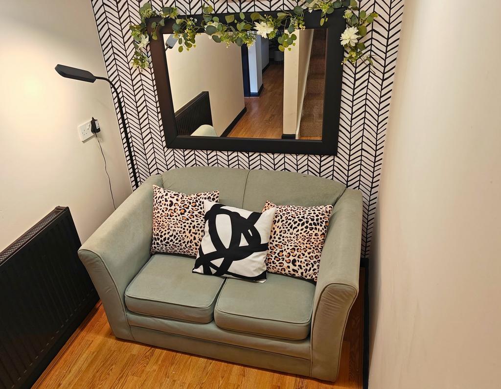 Cozy two-seater lounge niche with a soft mint-g...