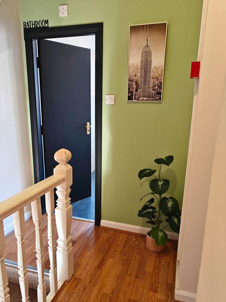 Bright, tidy landing with wooden flooring, deco...