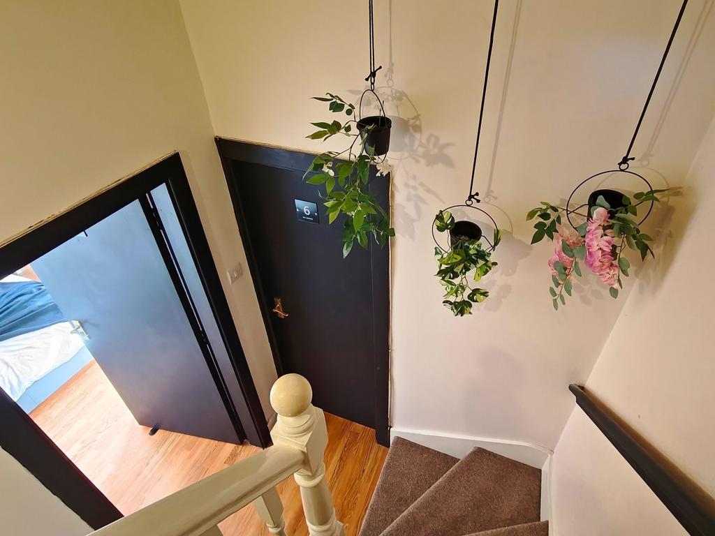 Well-kept stairway landing with decorative hang...