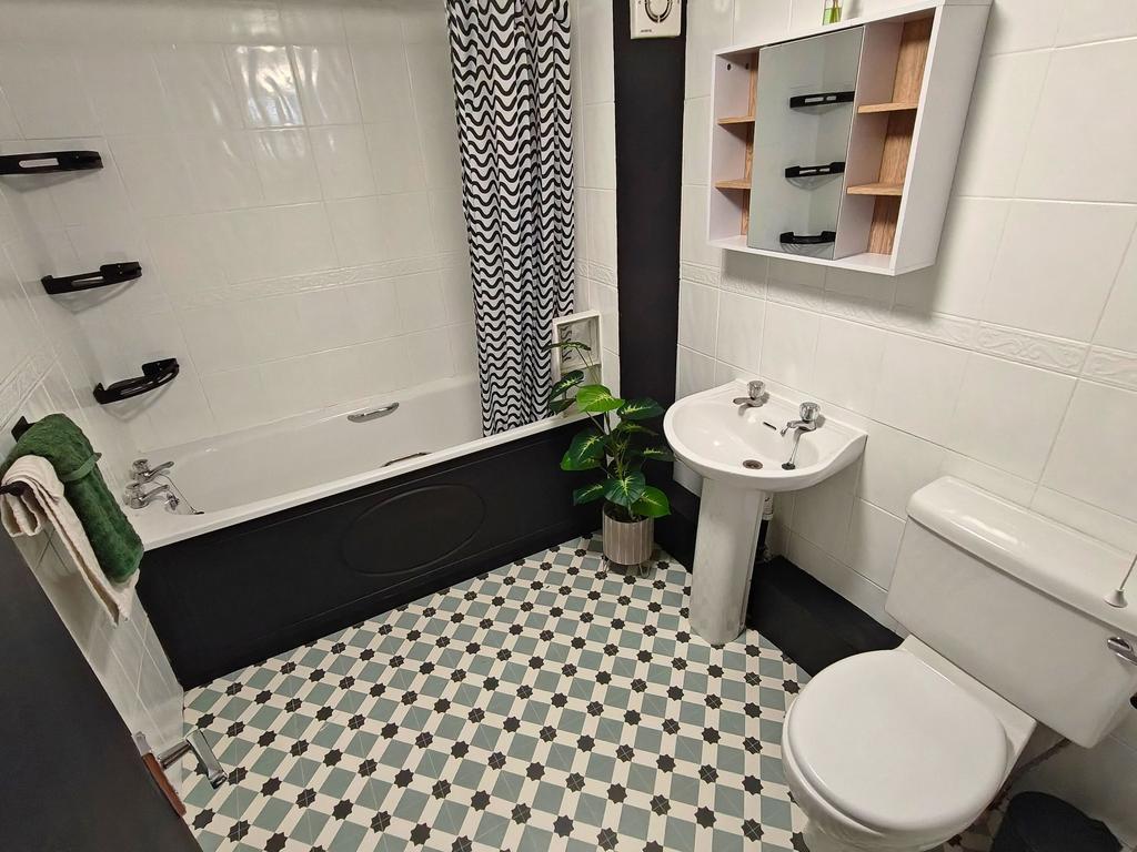 Bright, well-maintained bathroom with a stylish...