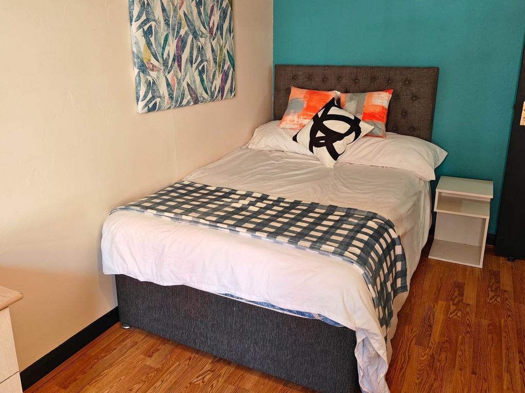 Bright, neatly presented bedroom with a comfort...