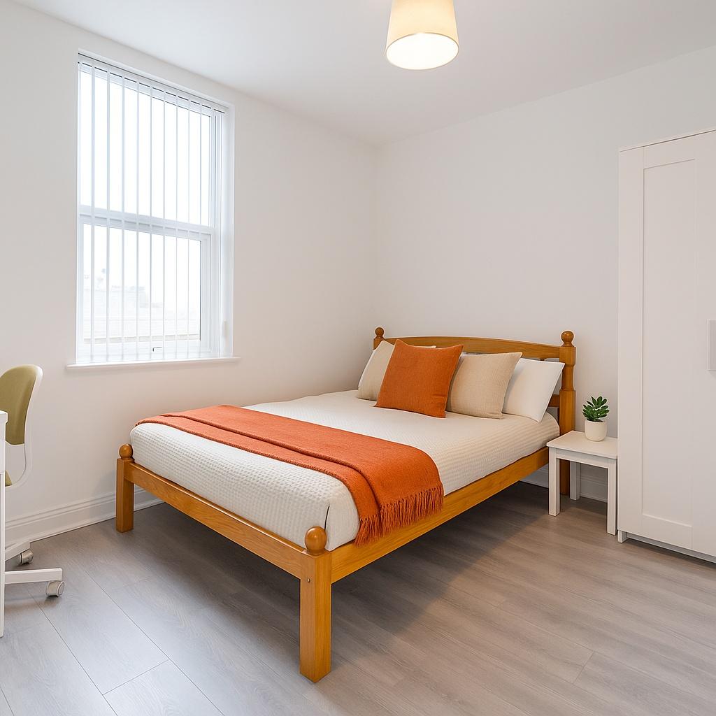 A clean, well-lit bedroom featuring a wooden be...