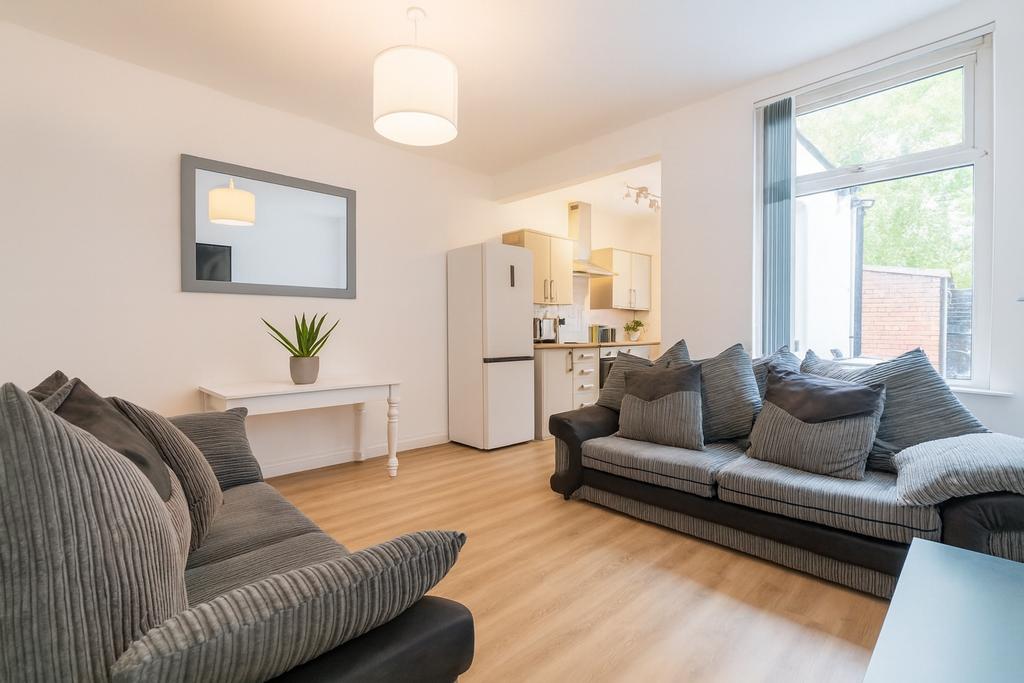 Bright, modern living room with large windows, ...