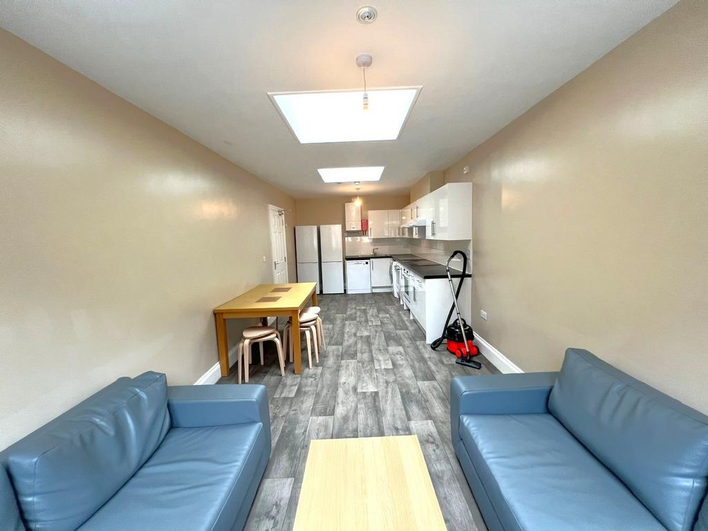 Bright open-plan living and kitchen area with t...