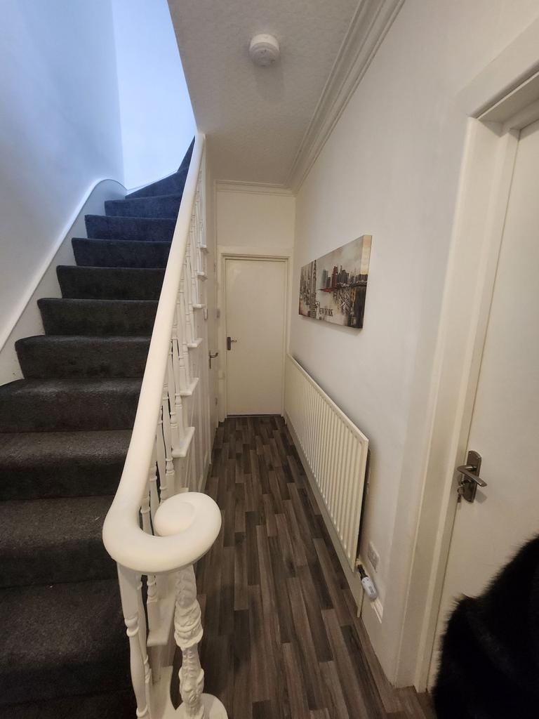 Bright, well-maintained hallway with a carpeted...