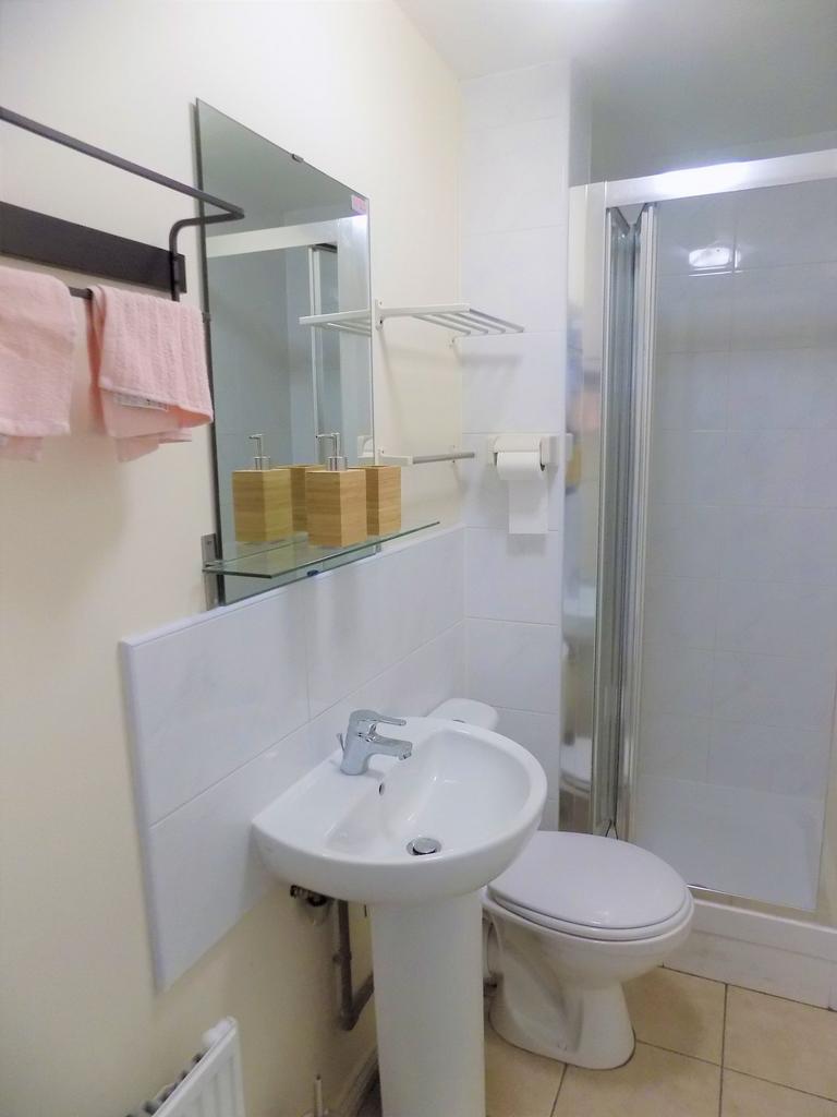 Bright, well-kept bathroom with a pedestal sink...