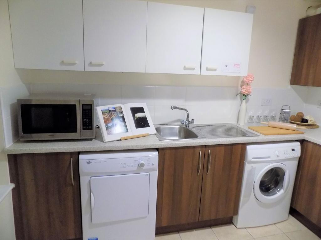 Bright, tidy kitchen with laminate worktops, in...