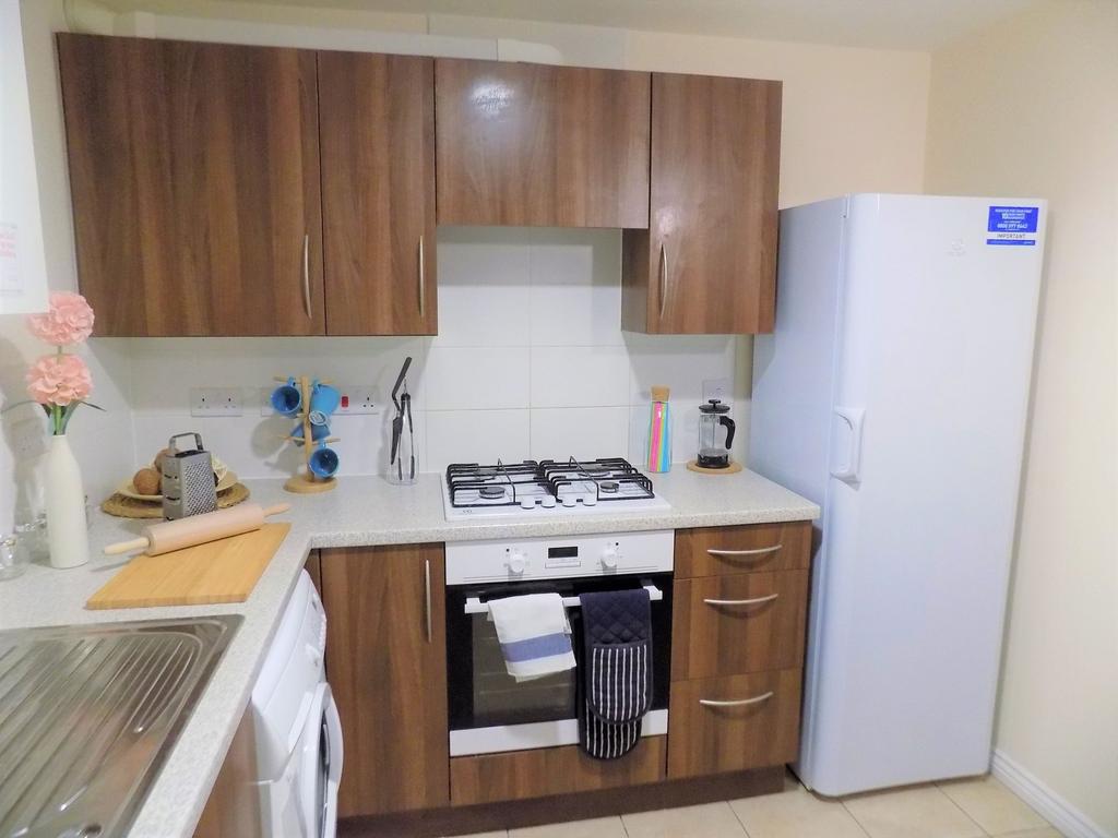 Bright, modern kitchen with warm wood-effect ca...
