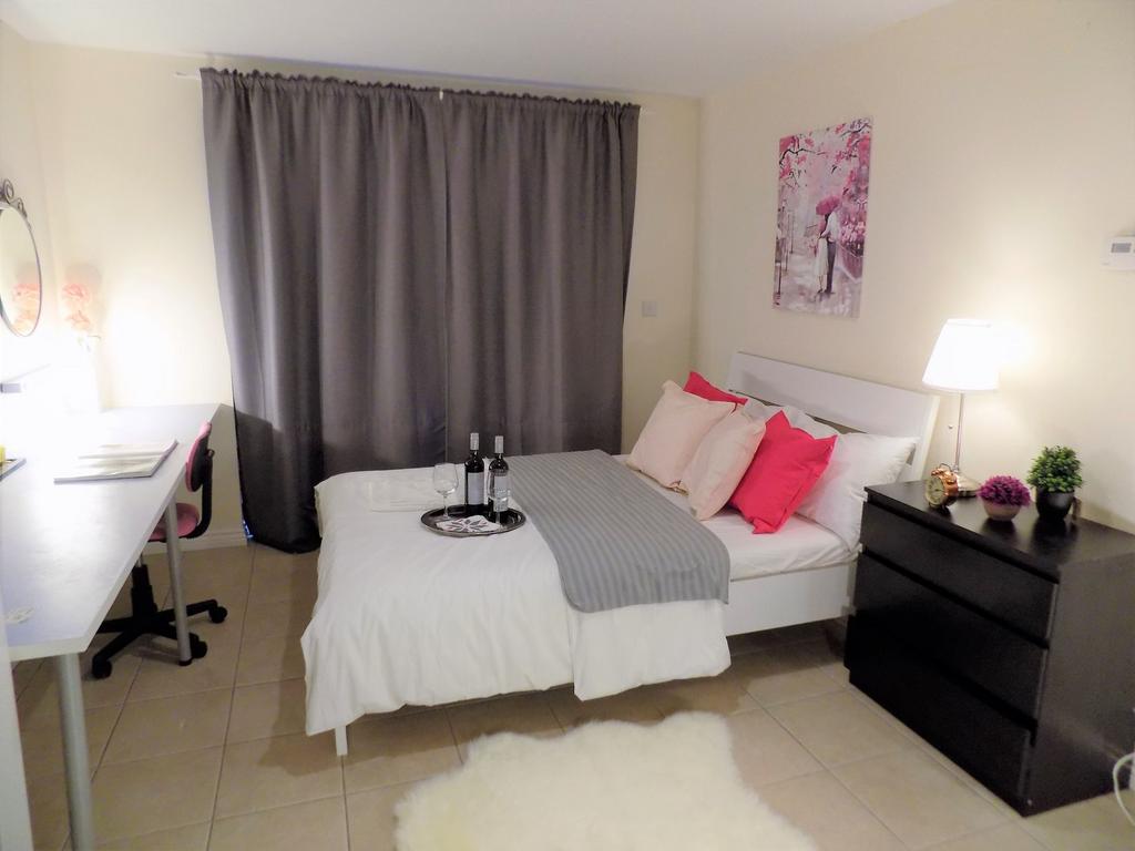 Bright, neatly styled double bedroom with a whi...