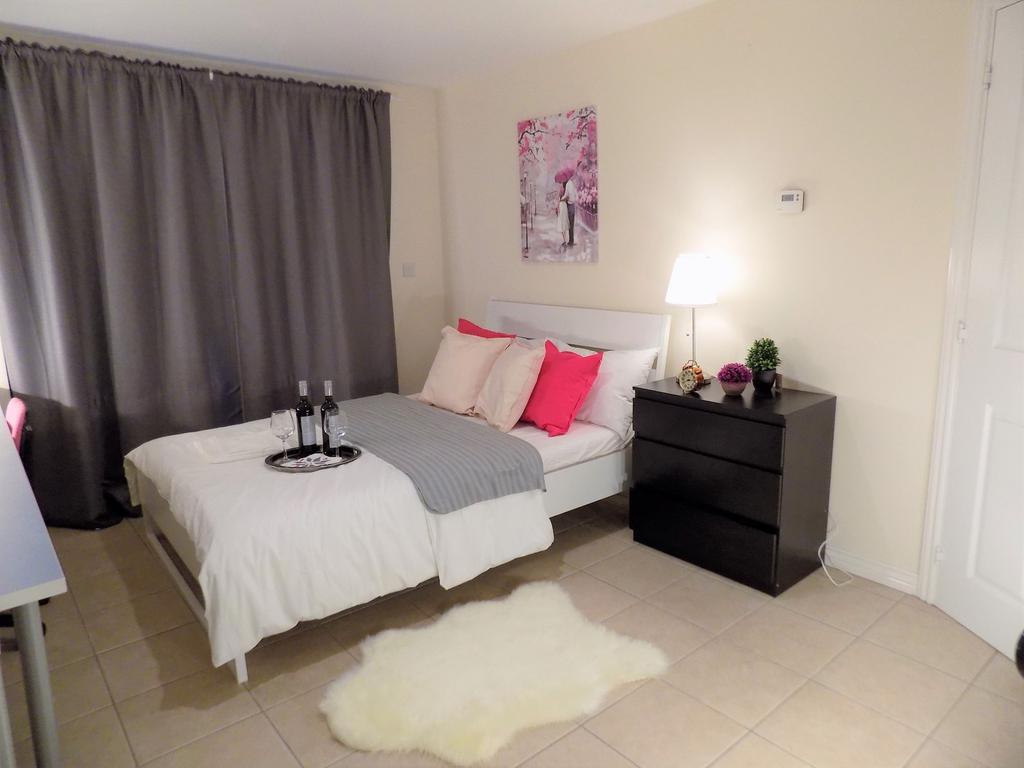 Bright, neatly styled double bedroom with a com...