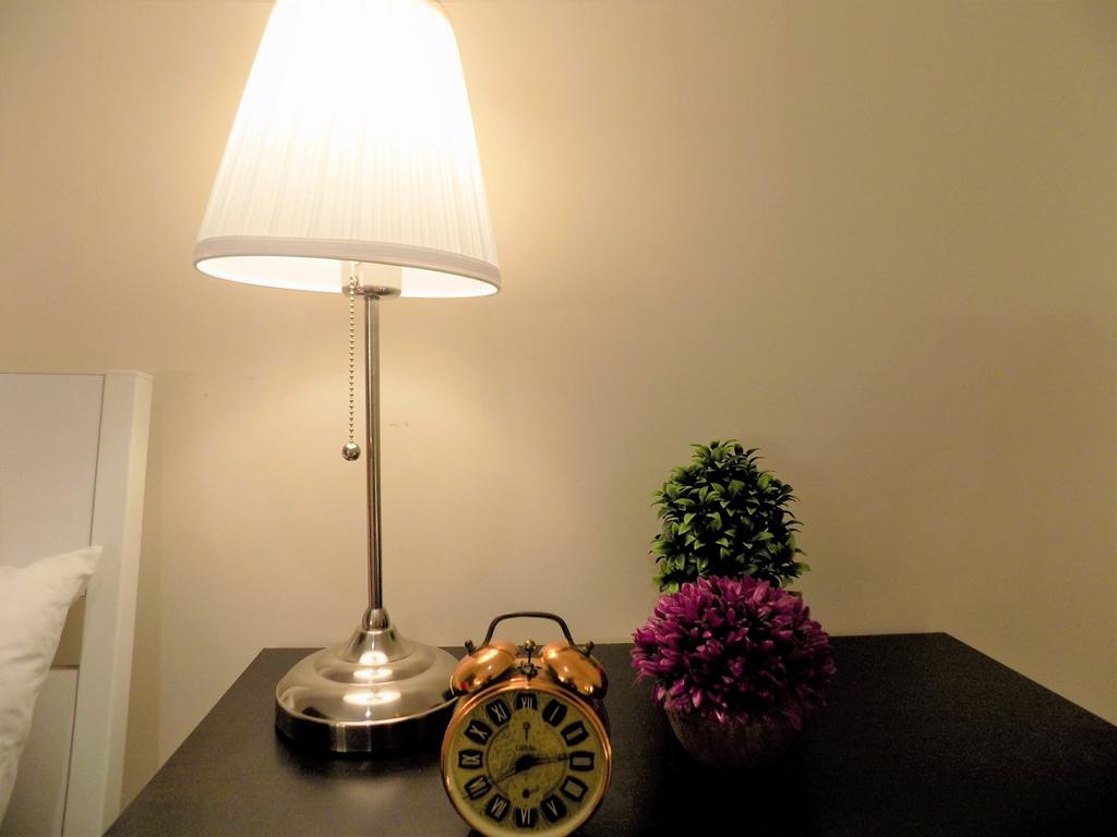 Well-lit bedside table with a modern metal lamp...