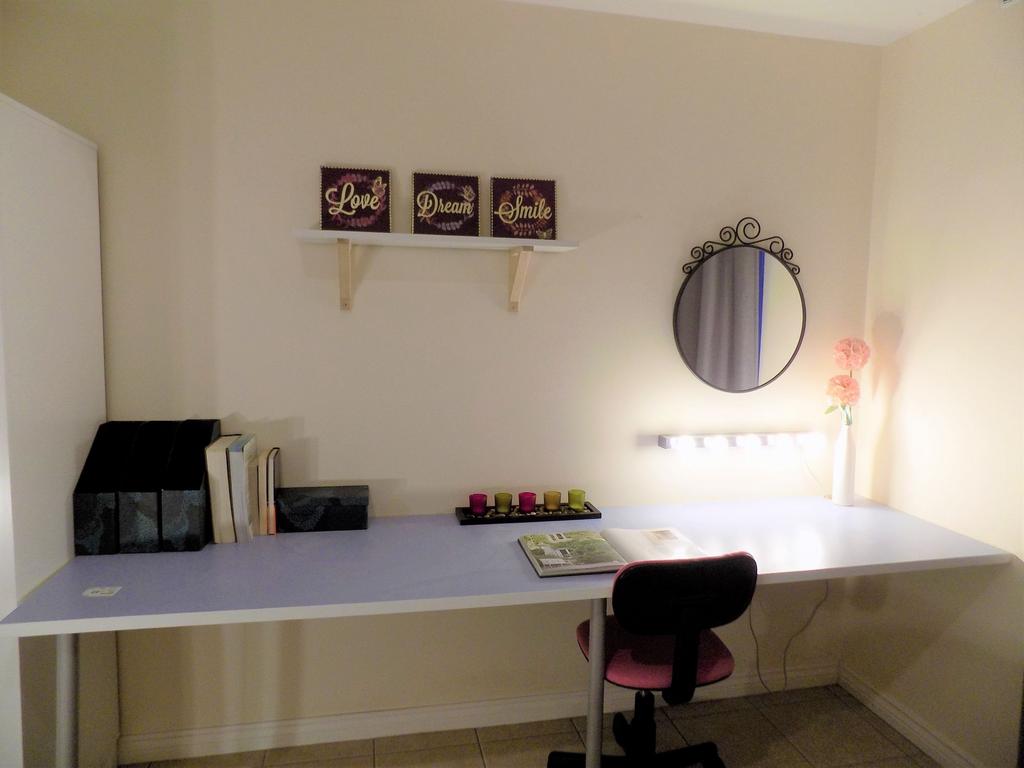 Bright, tidy study nook with a long work surfac...
