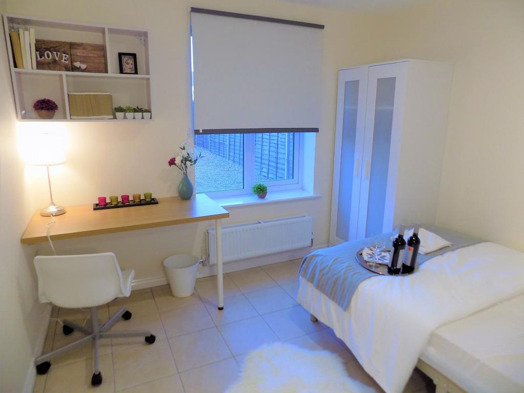 Bright, neatly styled single bedroom with a tid...