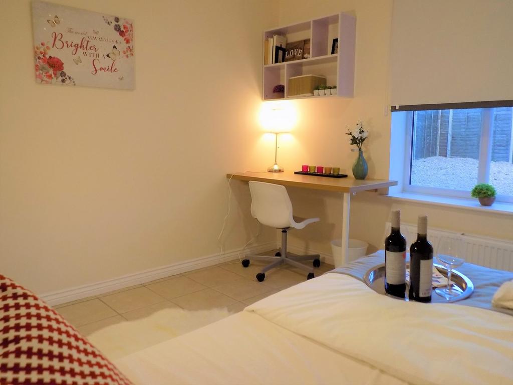 Bright, tidy bedroom with a study nook — featur...