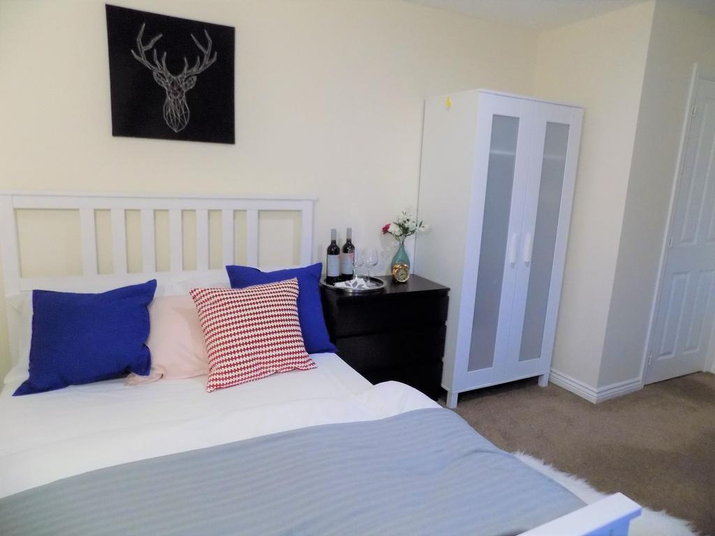 Bright, neatly presented bedroom with a white s...