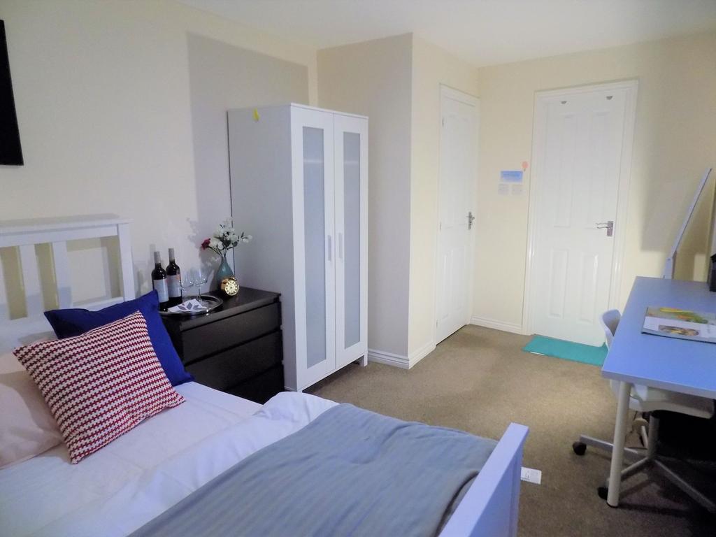 Bright, neatly styled bedroom with a double bed...