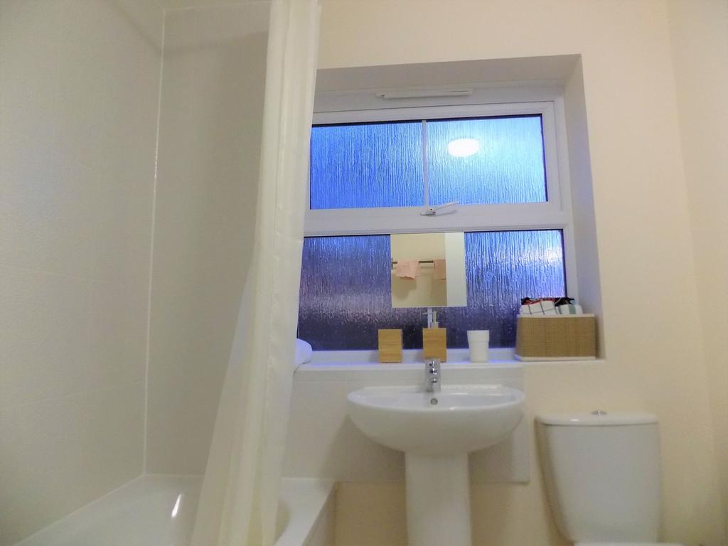Bright, tidy bathroom with a bathtub and shower...
