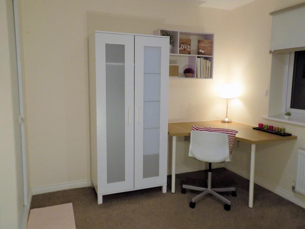 Well-presented bedroom corner with a white ward...