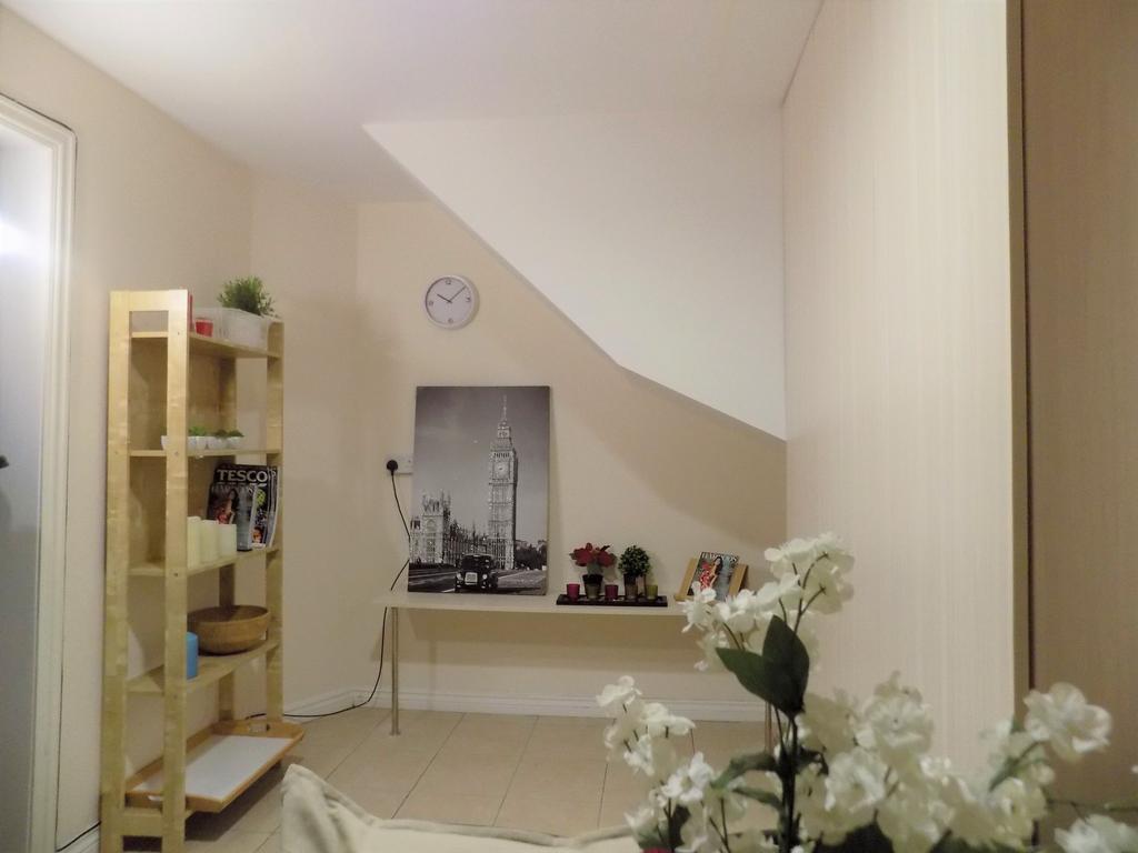 Bright, neatly furnished living area with neutr...