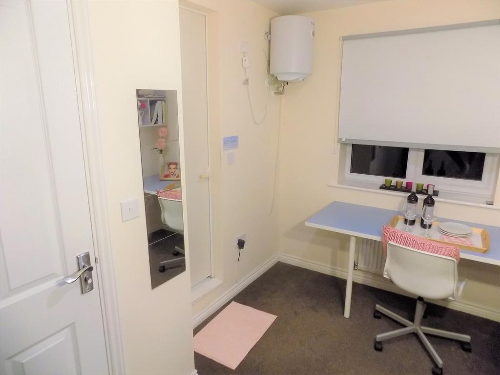 Neat, compact bedroom with a simple study setup...