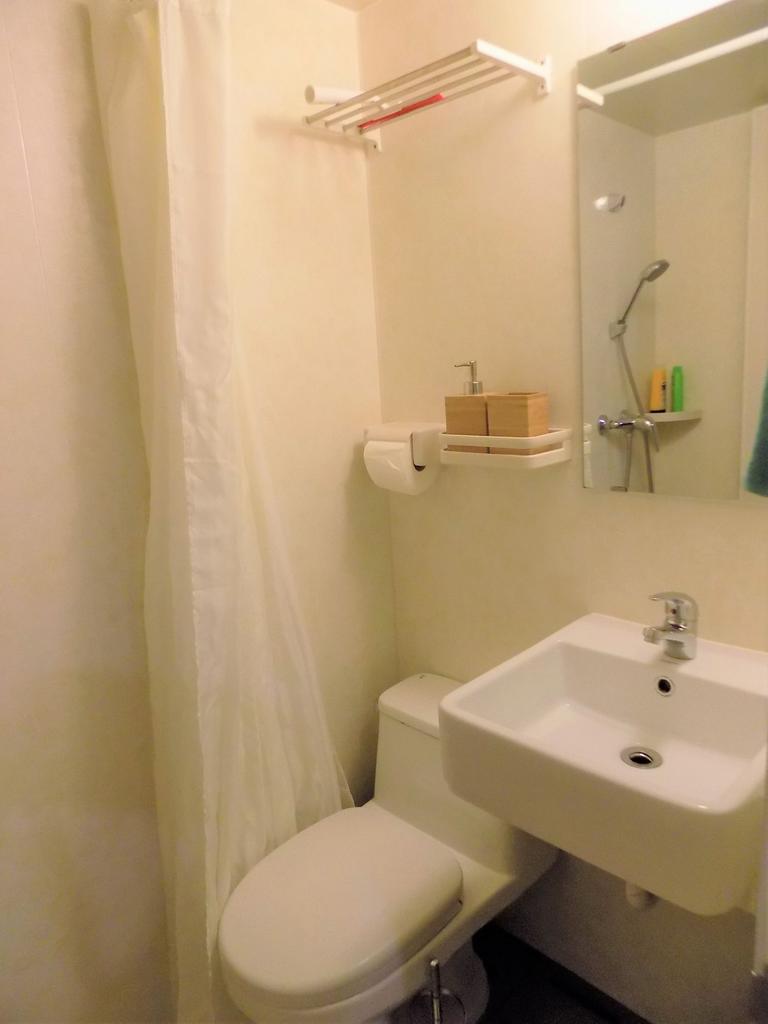 Compact, tidy bathroom with a modern sink, clos...