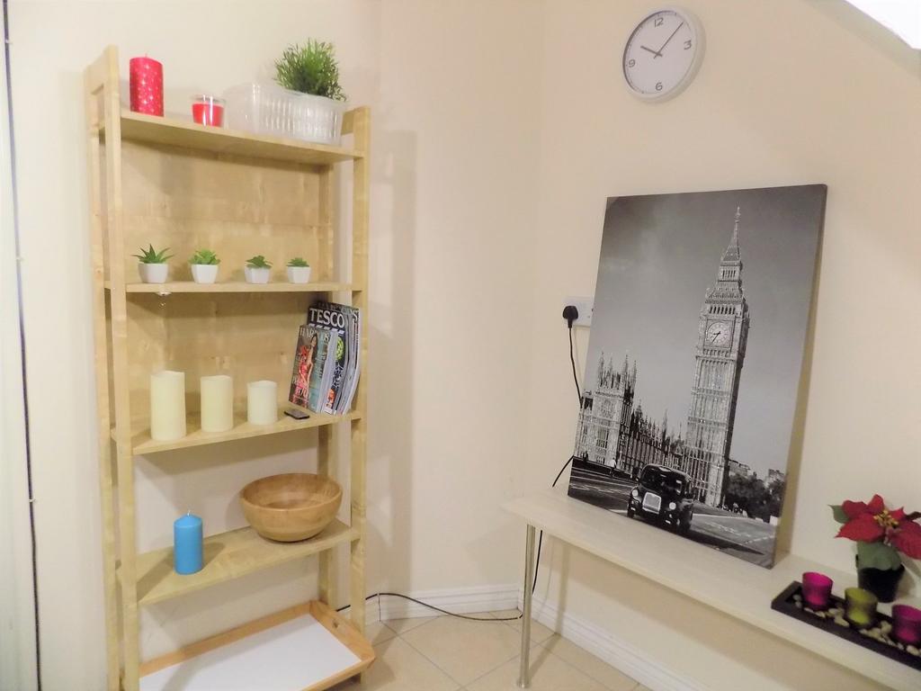 Neat corner of a living area featuring a light ...