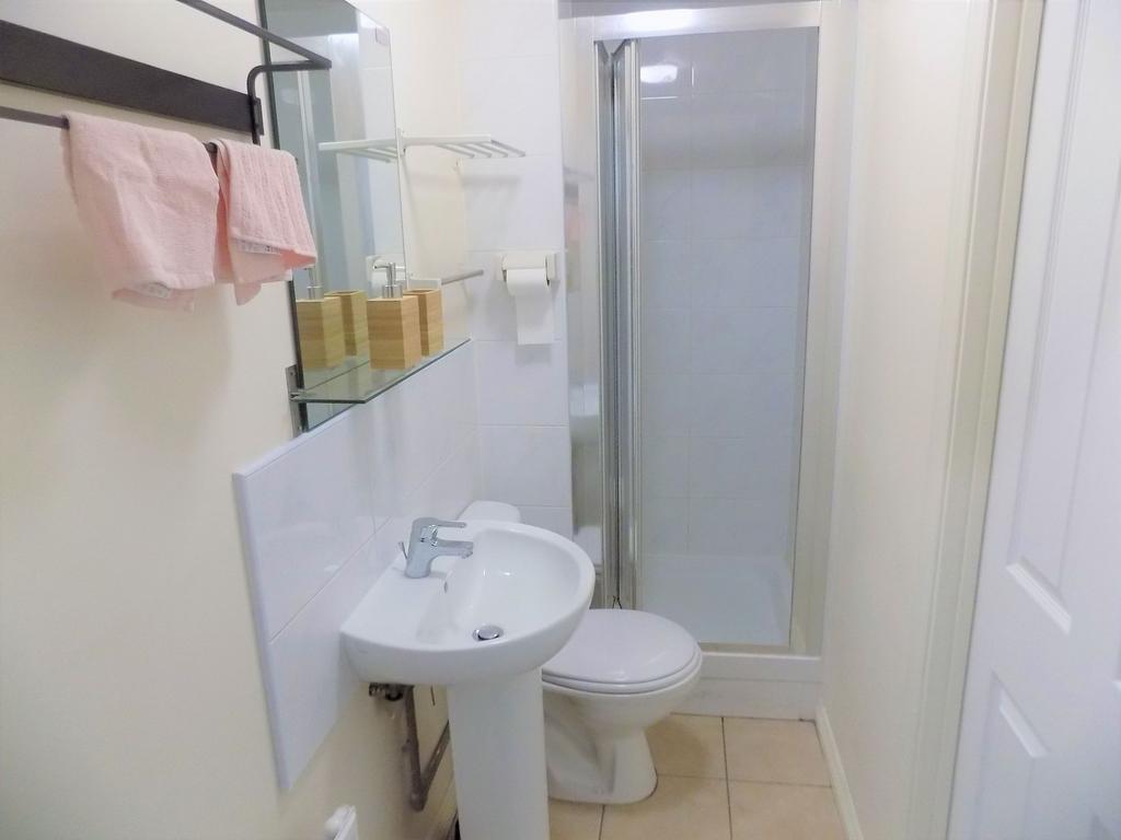 Bright, tidy bathroom with a corner shower cubi...