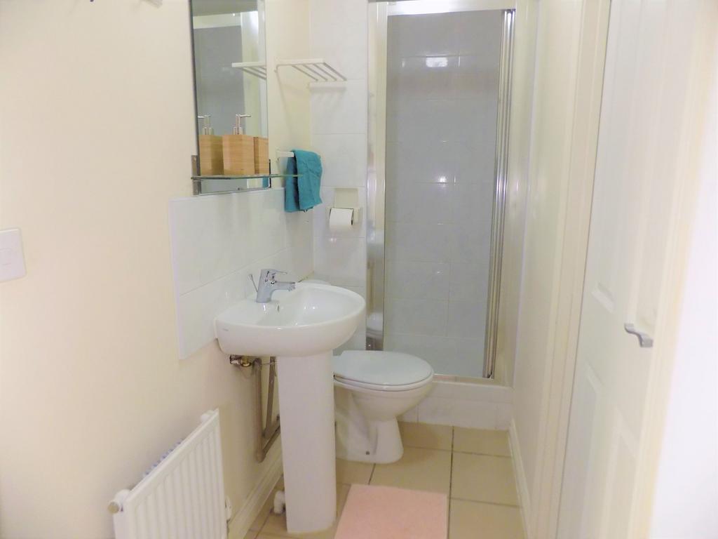 Bright, tidy bathroom with a pedestal sink, toi...
