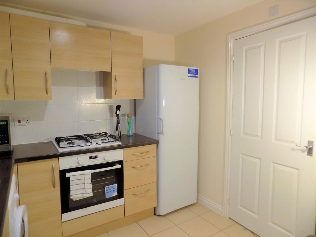 Neat modern kitchen with fitted oven and gas ho...