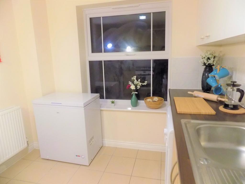Bright, neatly presented kitchen with tiled flo...