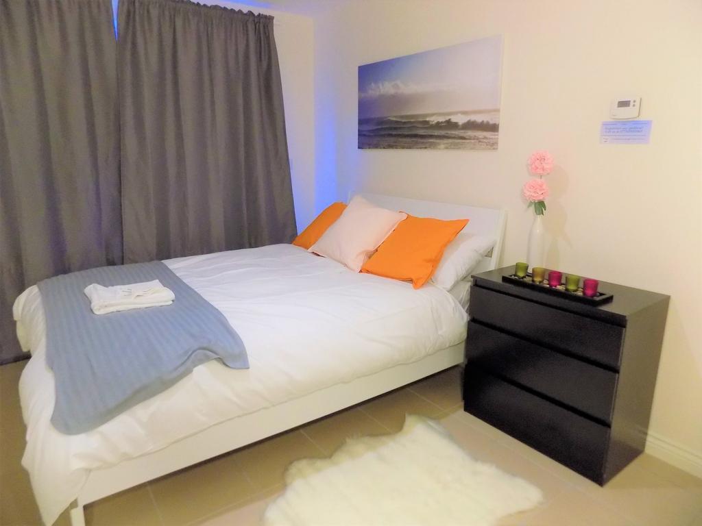 Bright, neatly styled double bedroom with a whi...
