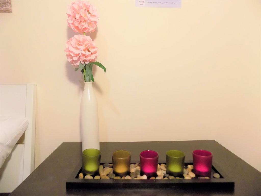Stylish bedside setup with a tall white vase ho...