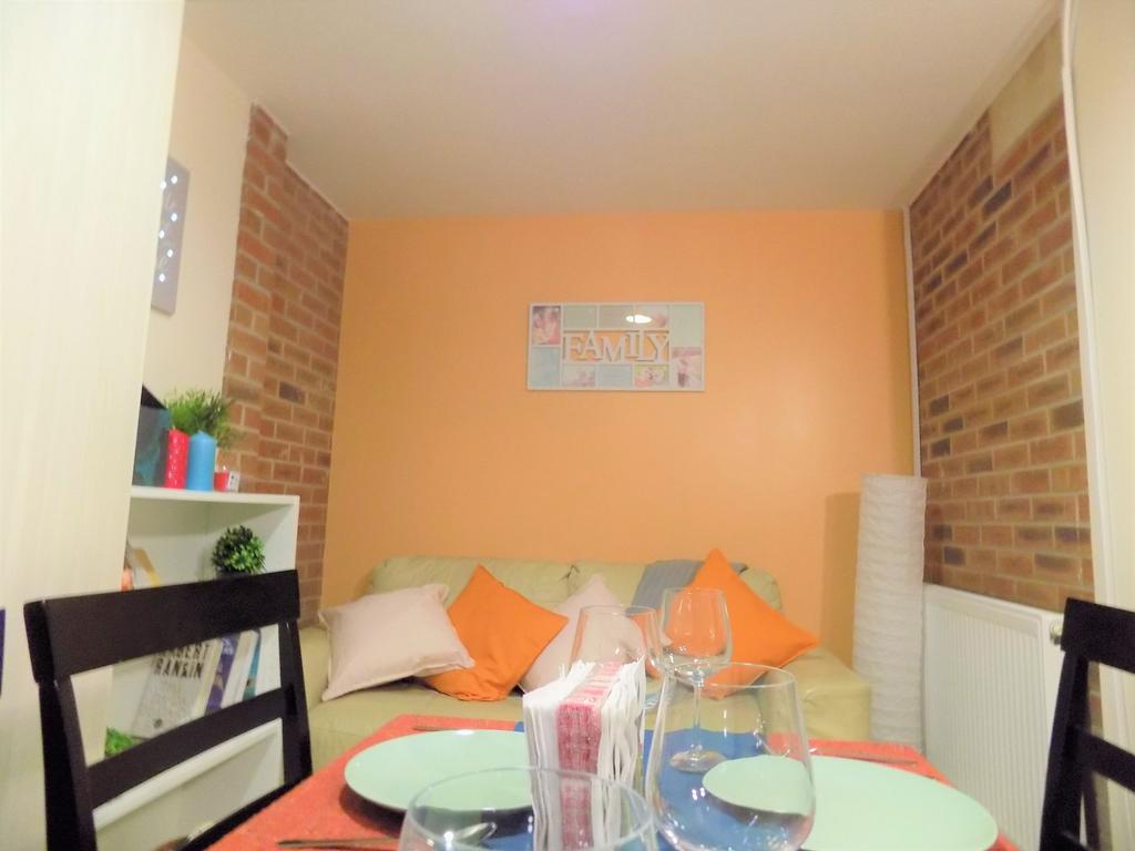Cosy, well-decorated living area with a pale so...