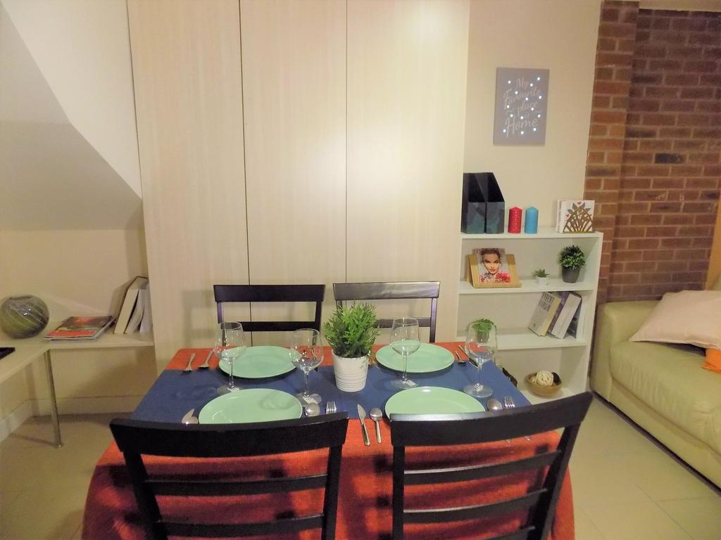 Bright, neatly set dining area in a living spac...