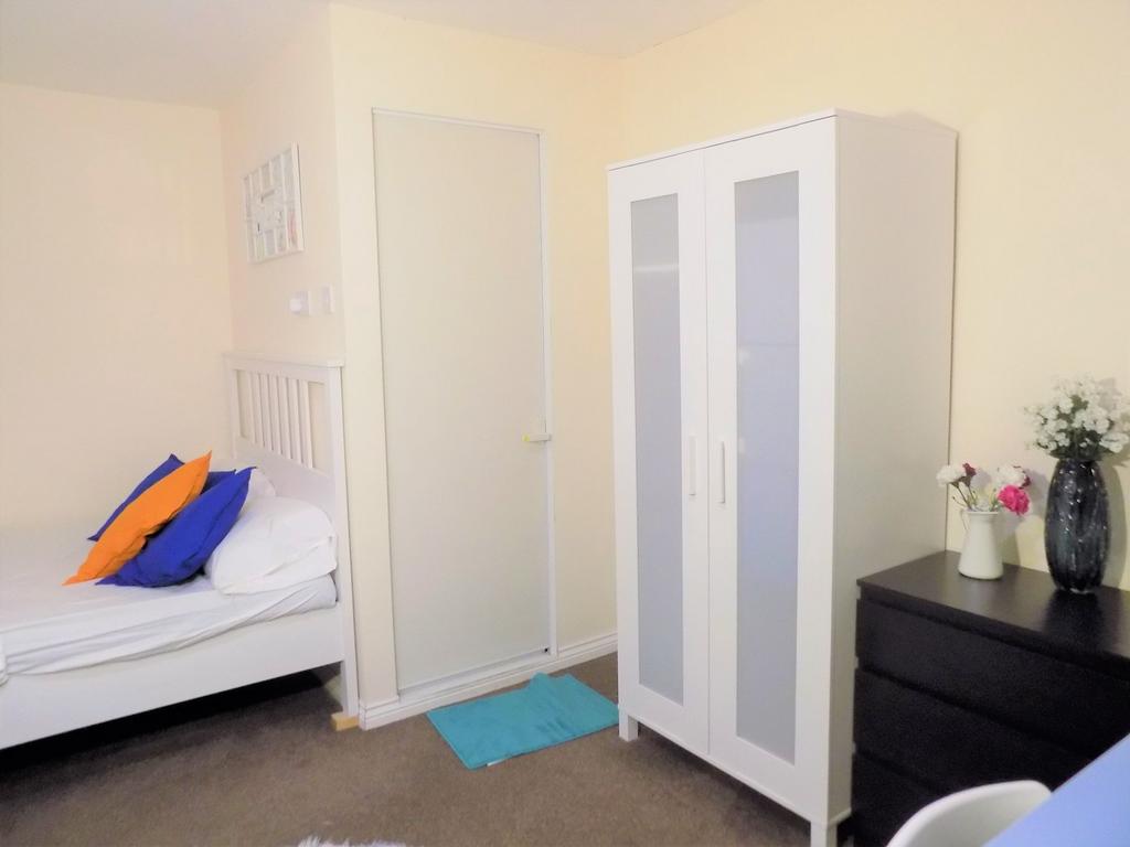 Bright, tidy bedroom with a white double bed, b...