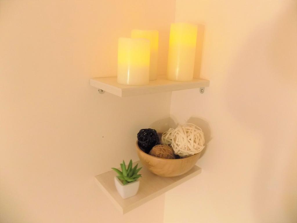 Decorative wall shelves with soft candle lighti...