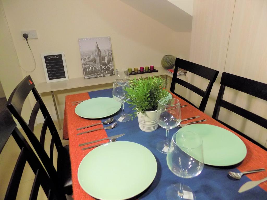 Bright, neatly set dining table with modern pla...