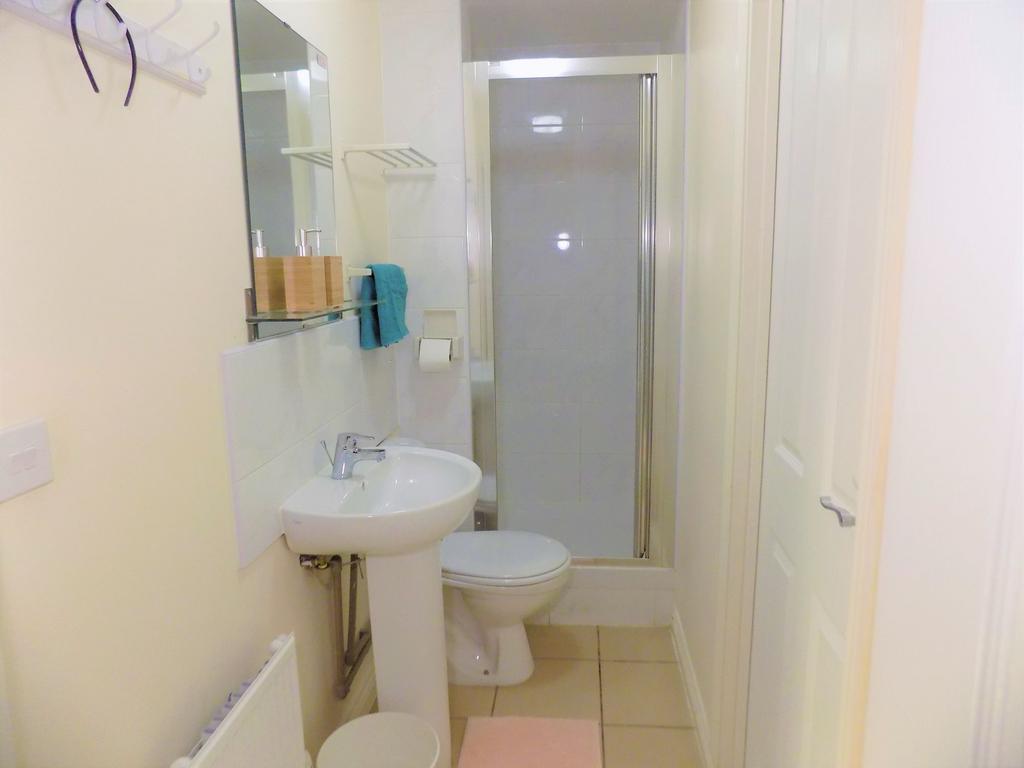 Neat, modern bathroom with a pedestal sink, toi...