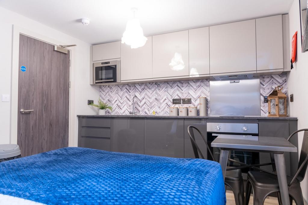 Modern studio-style room with integrated kitche...