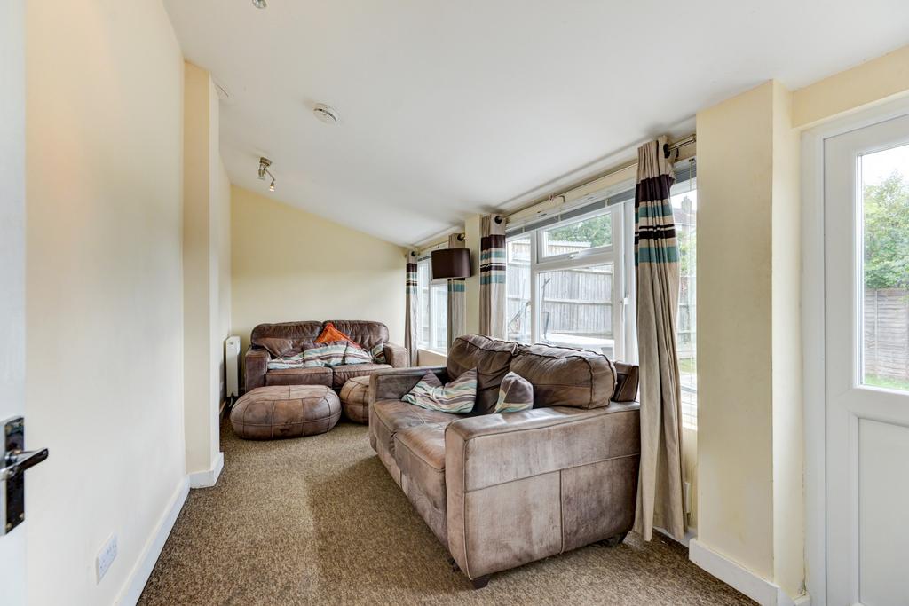 Bright, comfortable living room with large wind...