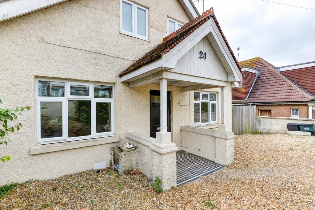Welcoming detached house entrance with covered ...