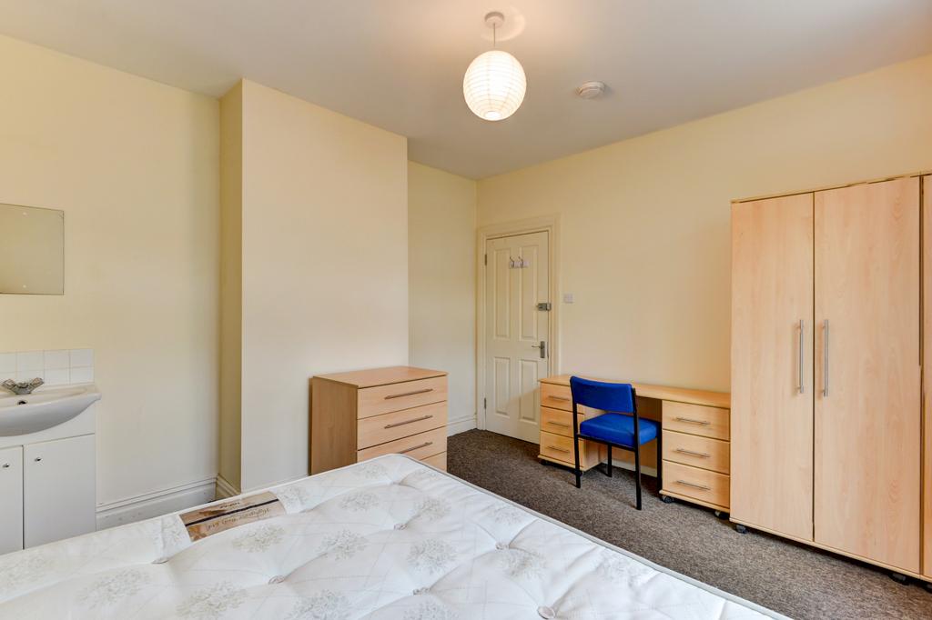 Bright, neutrally decorated double bedroom with...