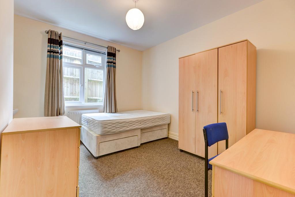 Bright, neatly presented bedroom with a comfort...