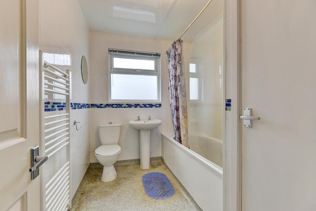 Bright, well-kept bathroom with a bathtub and o...