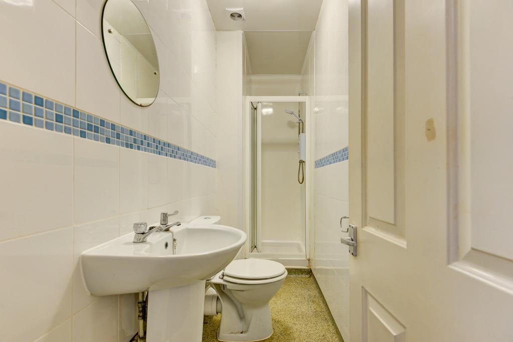 Clean, well-maintained bathroom with a pedestal...