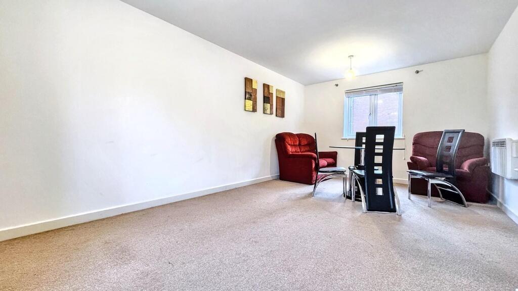 Bright, simply furnished living room with neutr...