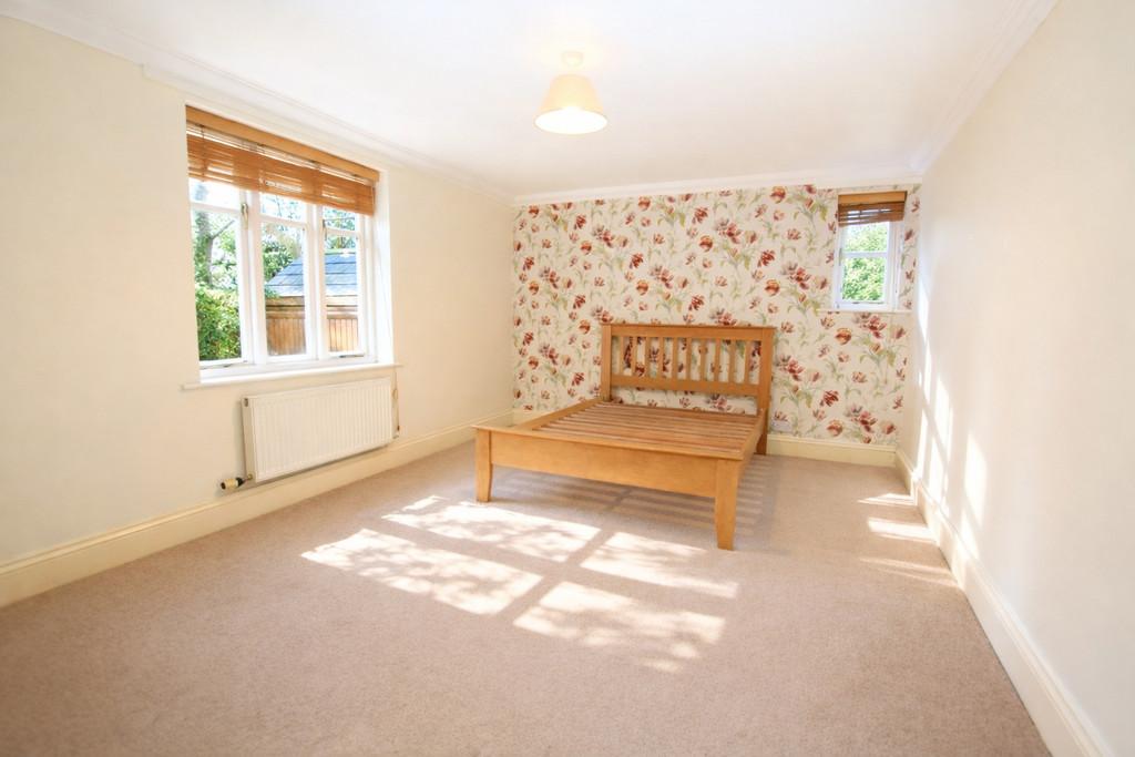 Sunlit bedroom with floral wallpaper